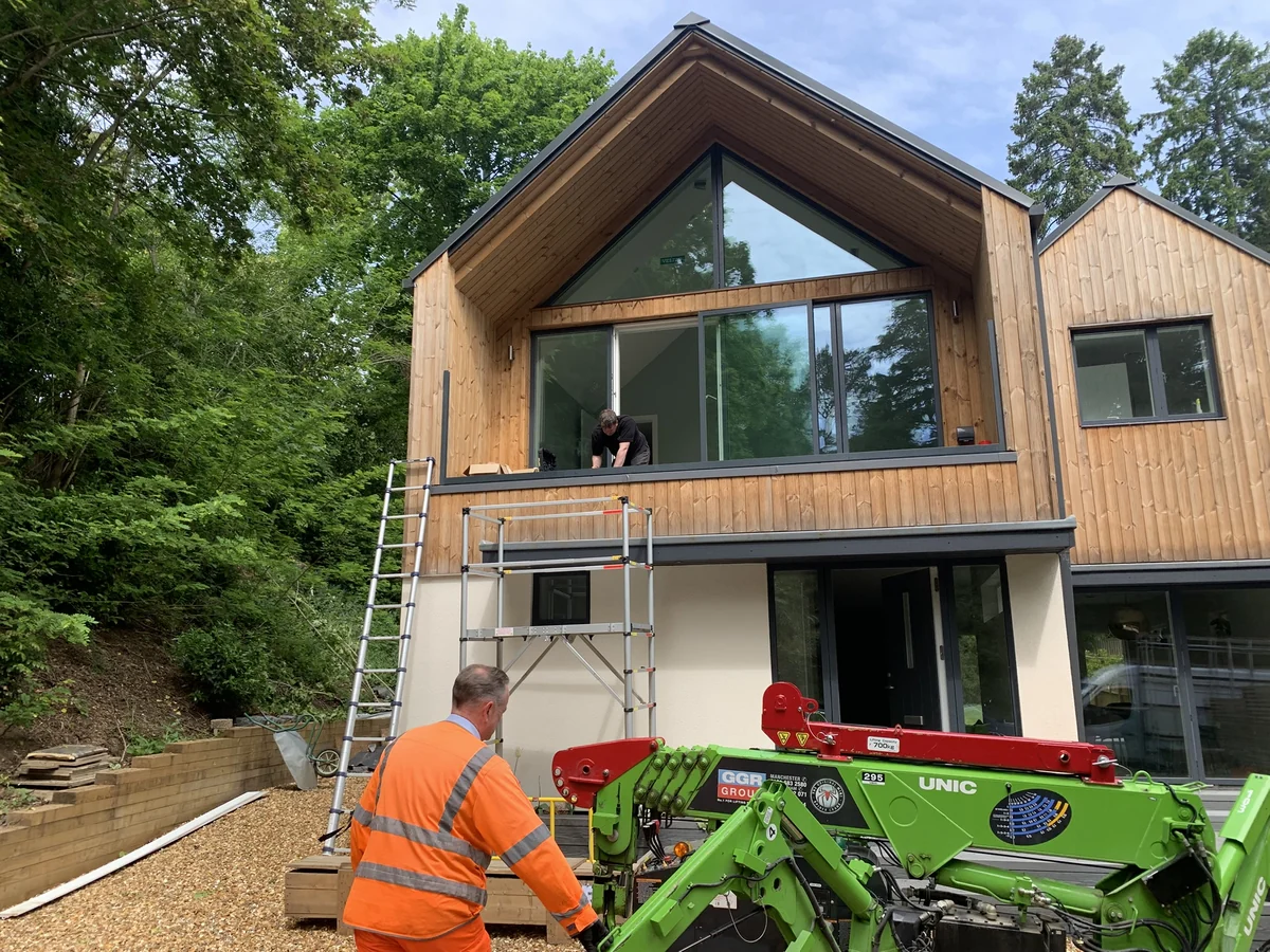 Installation of bespoke glass balustrade at a timber home in Henley-on-Thames, specialist crane lifting equipment in use