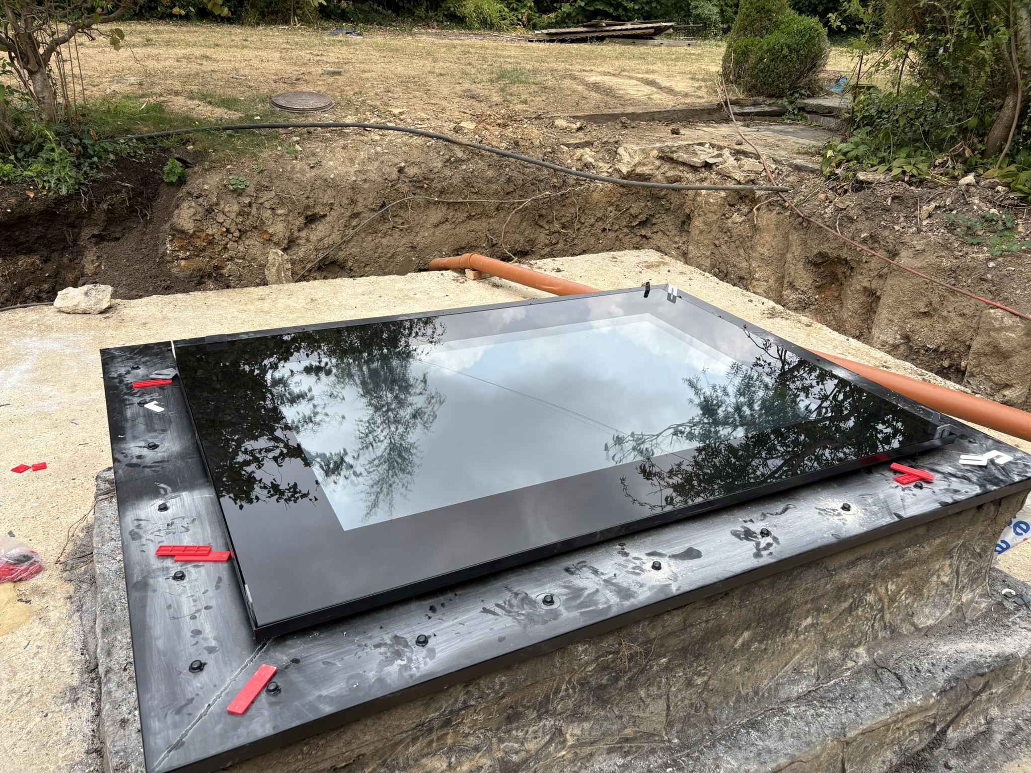 Walk-on skylight being positioned into prepared opening