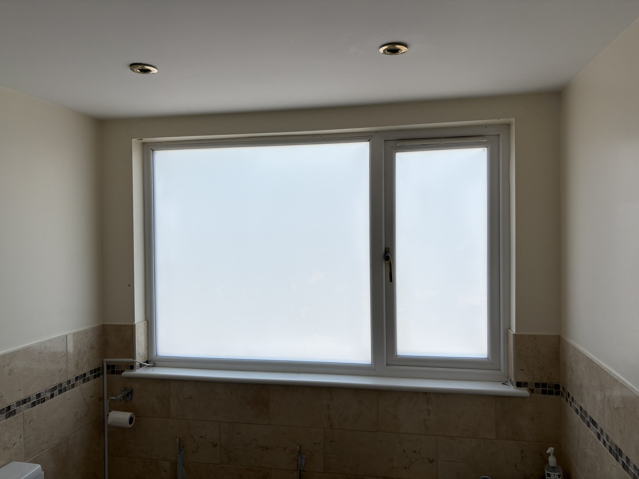 Switchable glass window in opaque privacy mode — bathroom overlooking Torbay