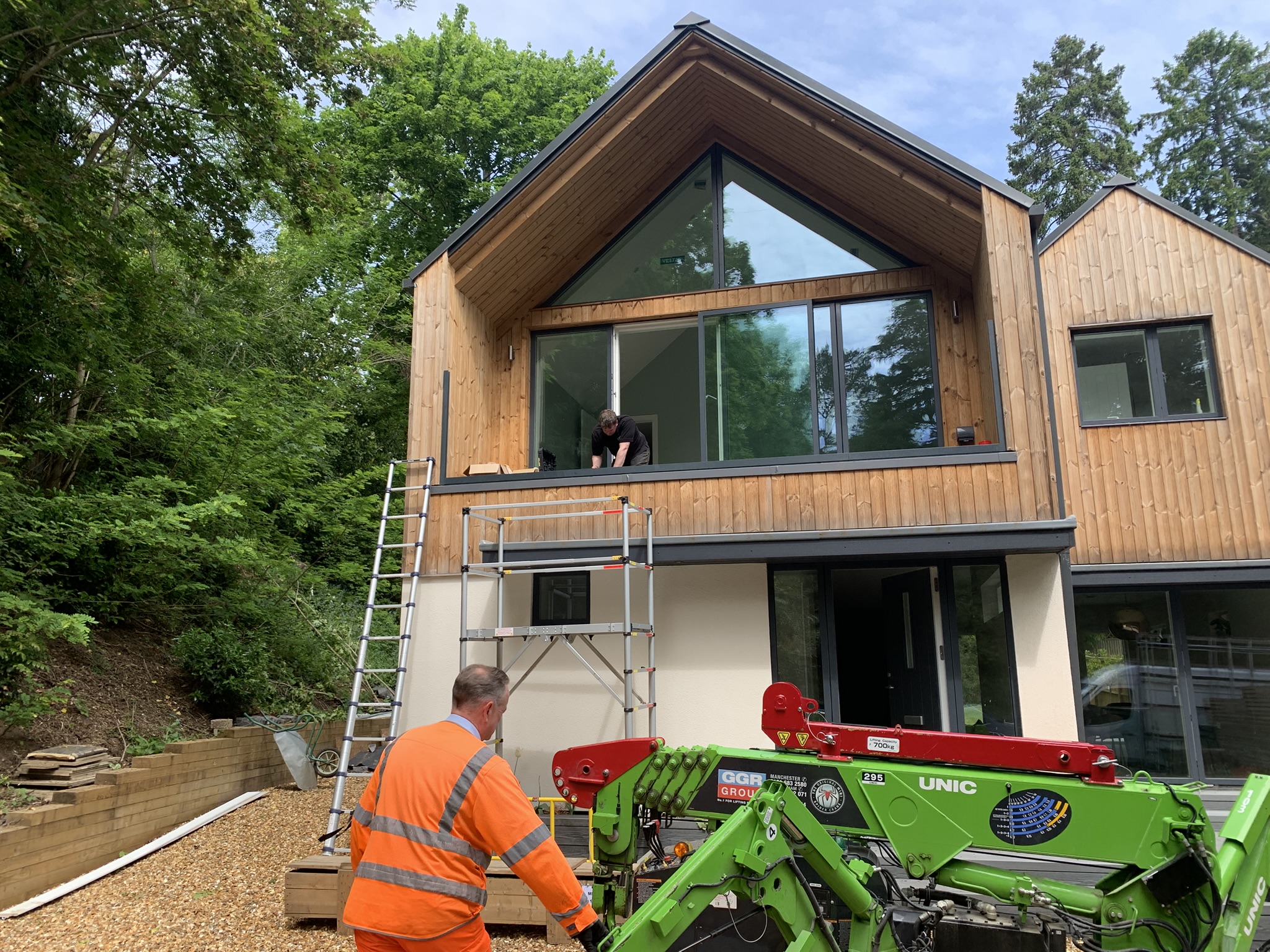 Installation of bespoke glass balustrade at a timber home in Henley-on-Thames, specialist crane lifting equipment in use