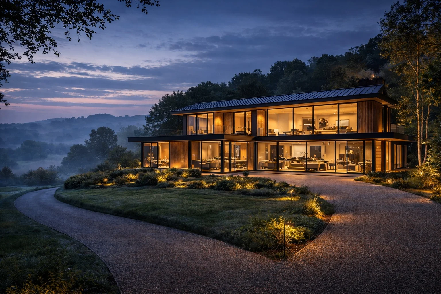 Glass-walled countryside home at twilight